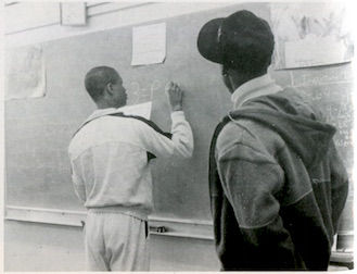 student working at chalkboard